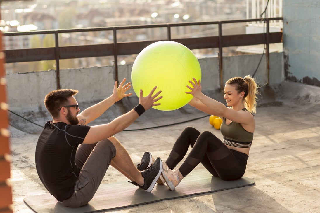 Pilates ball passing exercise